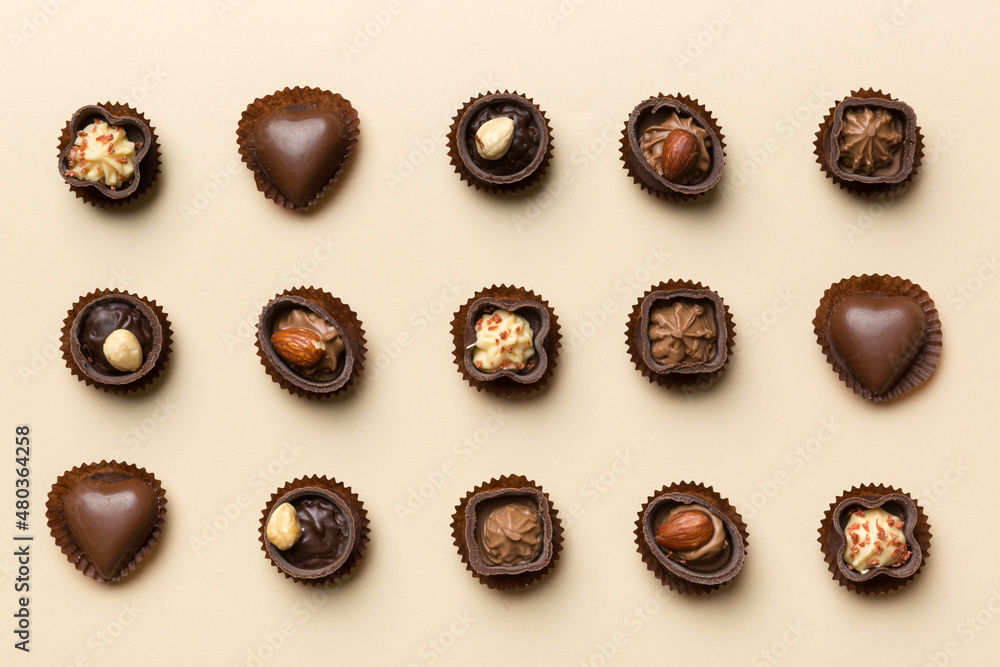 Different kinds of chocolates on colored table close-up. Top View and Flat Lay Different kinds of chocolates on colored table close-up. Top View and Flat Lay