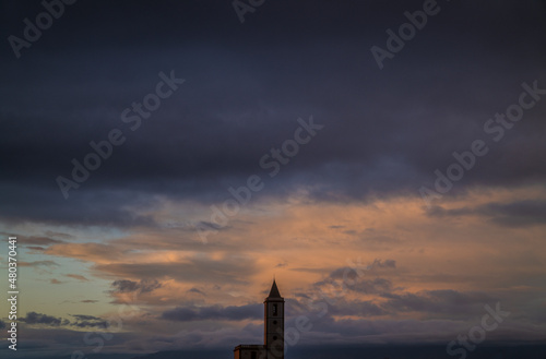 Church tower against cloudy sky during sunset. Las Salinas, Cabo de Gata Nature Park, Almeria, Spain © WeeKwong