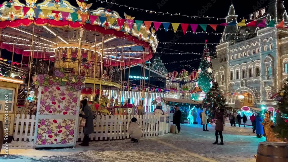 New Year's carousel at Christmas Fair on Red Square Night winter snow Moscow, Russia, December 19, 2021 High quality 4k footage. High quality 4k footage New Year's carousel at Christmas Fair on Red Square Night winter snow Moscow, Russia, December 19, 2021 High quality 4k footage. High quality 4k footage