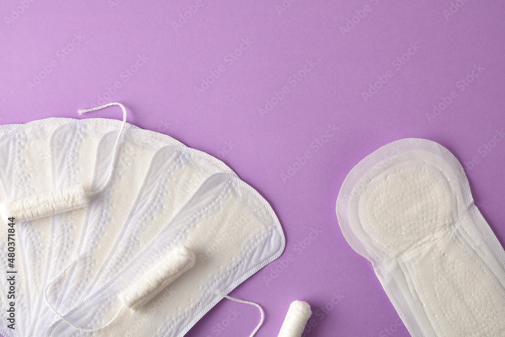 Obraz premium Feminine menstrual tampon and pads pack on lilac background top