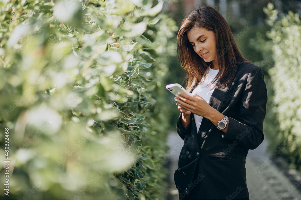 Business woman talking on the phone in park
