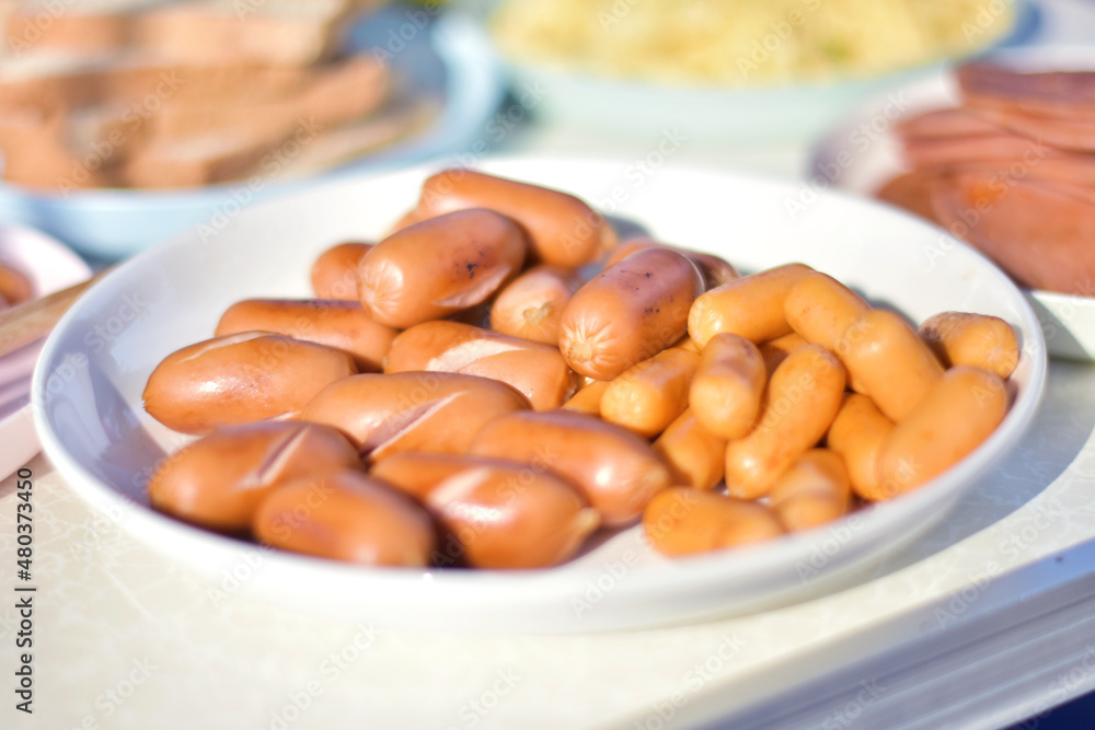 Grilled sausages on a plate ready to serve looks appetizing for a simple breakfast. Grilled sausages on a plate ready to serve looks appetizing for a simple breakfast.