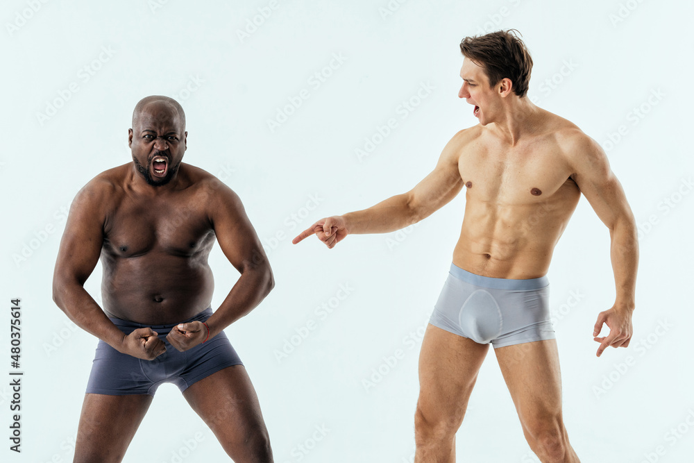 two multiethnic men posing for a male edition body positive beauty set.  Shirtless guys with different age, and body wearing boxers underwear Photos  | Adobe Stock