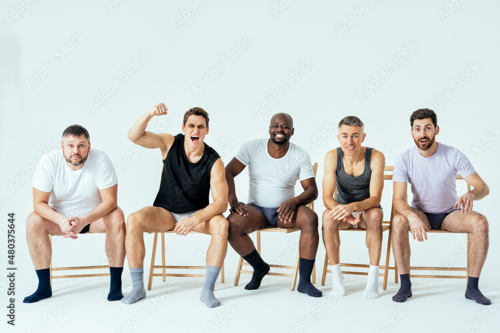 group of multiethnic men posing for a male edition body positive beauty set. Shirtless guys with different age, and body wearing boxers underwear group of multiethnic men posing for a male edition body positive beauty set. Shirtless guys with different age, and body wearing boxers underwear