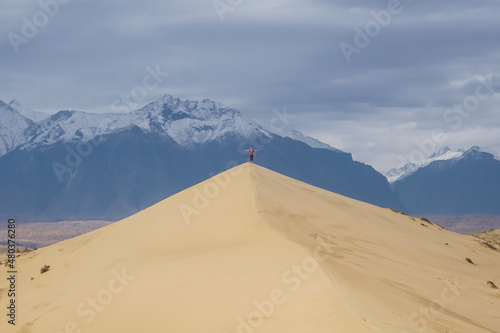Traveler at the Chara sand dunes