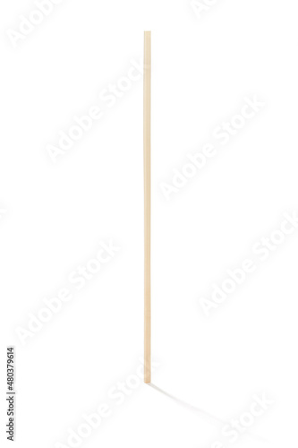 Detailed shot of a reusable bamboo straw. The thin straw is made of light natural wood. The eco-friendly cocktail straw is located on the white background.