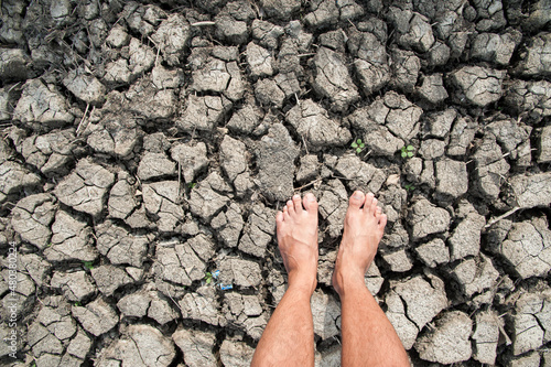 barefoot on dry and cracked ground or mud