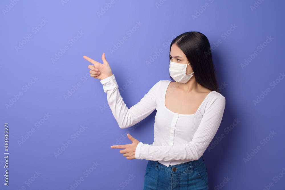 portrait of young woman is wearing face mask on Blue background portrait of young woman is wearing face mask on Blue background
