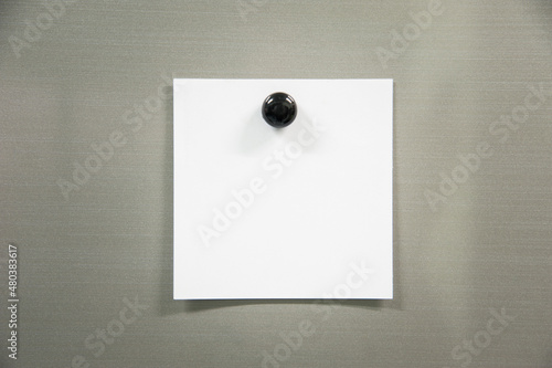 note paper with black pin on gray board