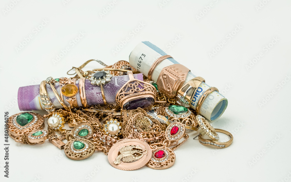Pile of gold jewelry on white background