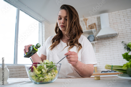 Woman preparing a salad in the kitchen