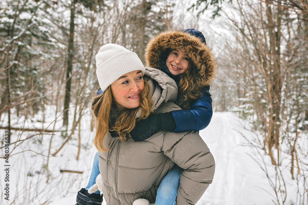 Handsome mother and his daughter are having fun outdoor in winter Handsome mother and his daughter are having fun outdoor in winter