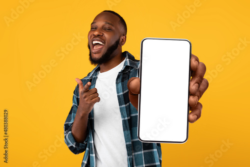 Black guy showing white empty smartphone screen, closeup photo