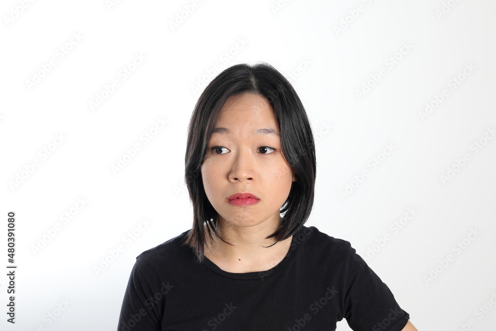 Young attractive south east asian woman pose face expression emotion on white background think worry annoyed Young attractive south east asian woman pose face expression emotion on white background think worry annoyed