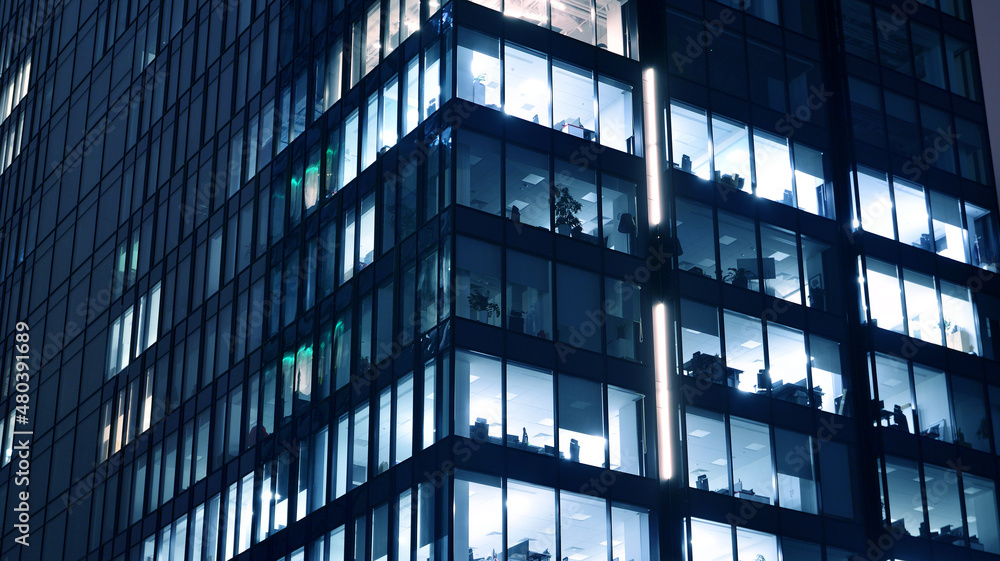 Amazing night cityscape. Office building at night, building facade with glass and lights. View with illuminated modern skyscraper. Scenic glowing windows of skyscrapers at evening. Amazing night cityscape. Office building at night, building facade with glass and lights. View with illuminated modern skyscraper. Scenic glowing windows of skyscrapers at evening.