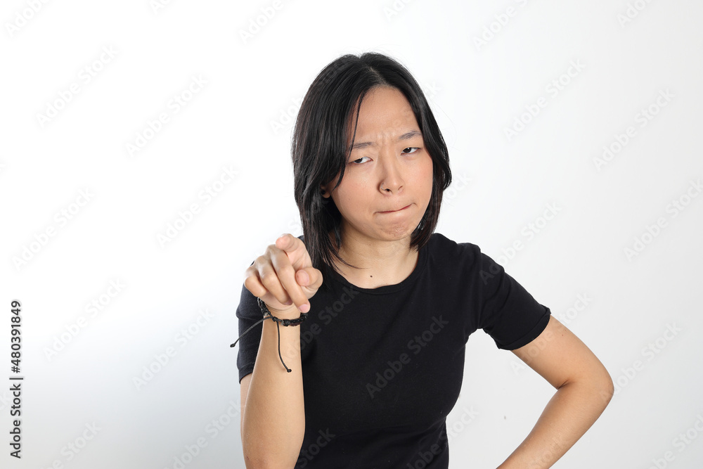 Young attractive south east asian woman pose face expression emotion on white background point finger thinking Young attractive south east asian woman pose face expression emotion on white background point finger thinking