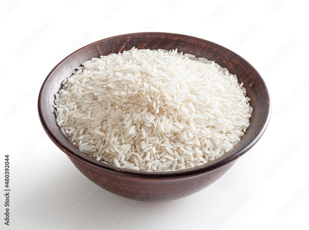 Uncooked jasmine rice in ceramic bowl isolated on white background with clipping path Uncooked jasmine rice in ceramic bowl isolated on white background with clipping path