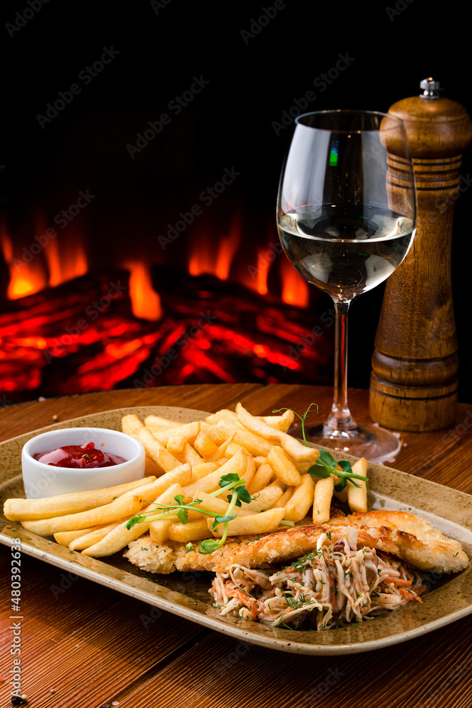 Fried chicken with french fries and salad, greens - junk food and unhealthy food. Fast food set fried chicken and french fries