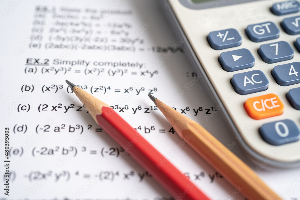 Pencil and calculator on mathematic formula exercise test paper in education school. Pencil and calculator on mathematic formula exercise test paper in education school.