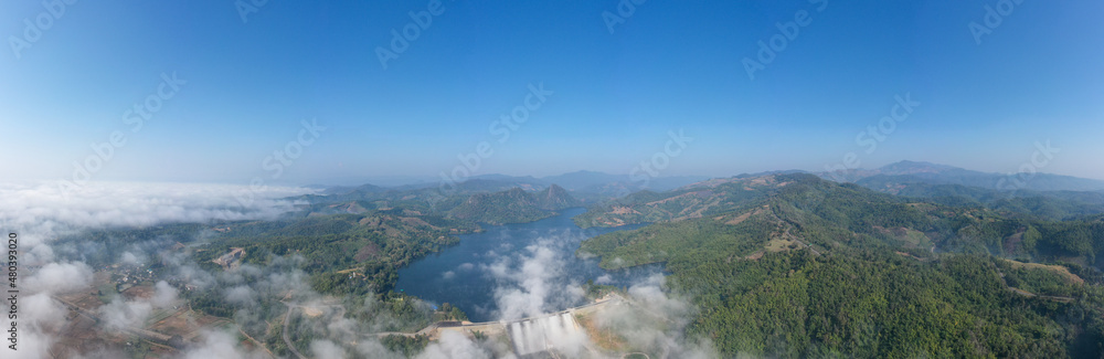 panorama landscape amazing view Mae Suai Dam or reservoir in a valley and blue sky at chiang rai Thailand, aerial view from drone for background