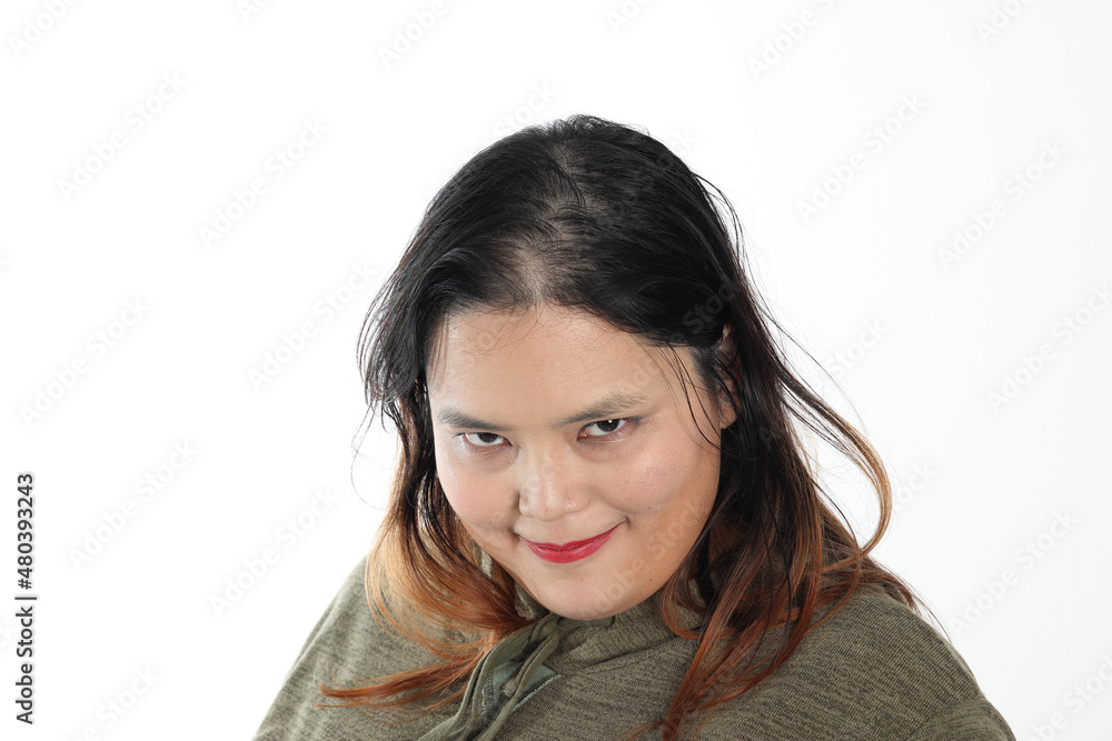Young plus size south east asian woman pose face expression emotion on white background smile villain Young plus size south east asian woman pose face expression emotion on white background smile villain