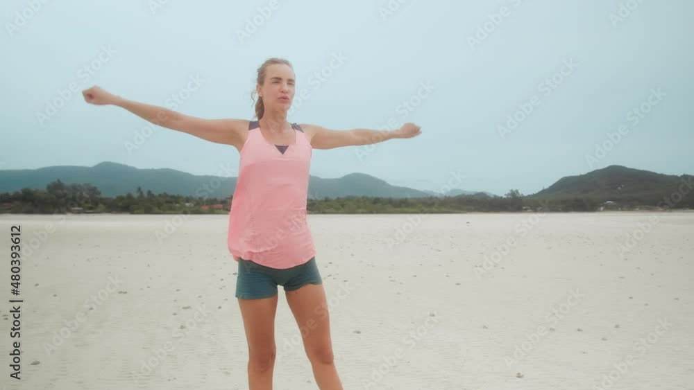 Fitness girl stretching warm up for exercise on the beach with tropical landscape view Fitness girl stretching warm up for exercise on the beach with tropical landscape view