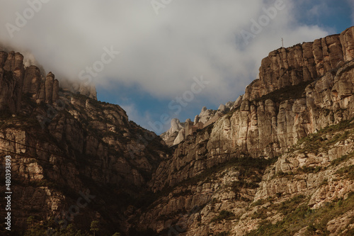 Clouds over the mountain cliffs in Montserrat , Spain