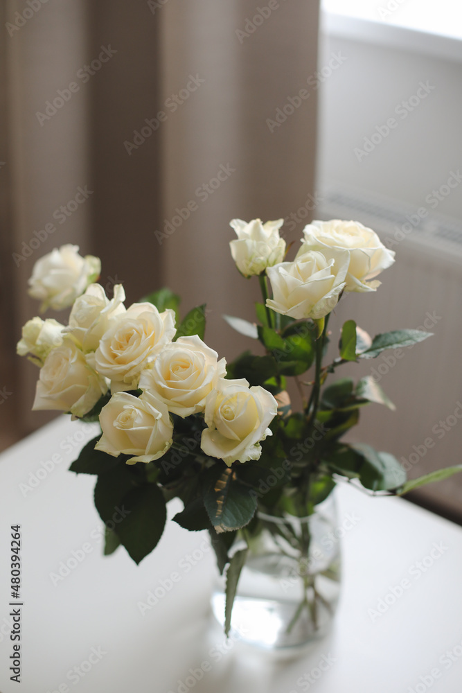 White rose bouquet in a cozy home interior. Floral spring background