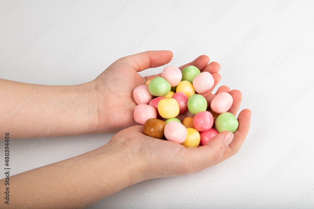 Child holding candy in his hands on white background Child holding candy in his hands on white background
