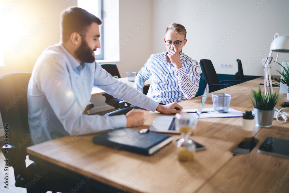 Professional caucasian 20s male colleagues having meeting to discuss planning and strategy for business partnership, skilled man employee talking with corporate owner share ideas for project Professional caucasian 20s male colleagues having meeting to discuss planning and strategy for business partnership, skilled man employee talking with corporate owner share ideas for project