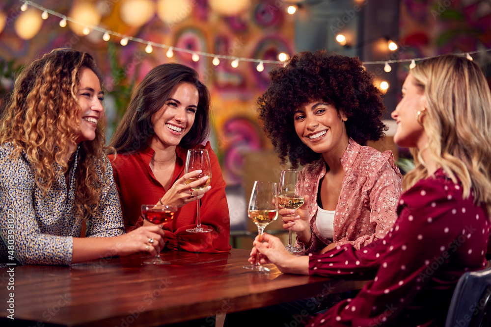 Multi-Cultural Group Of Female Friends Enjoying Party Night Out In Bar