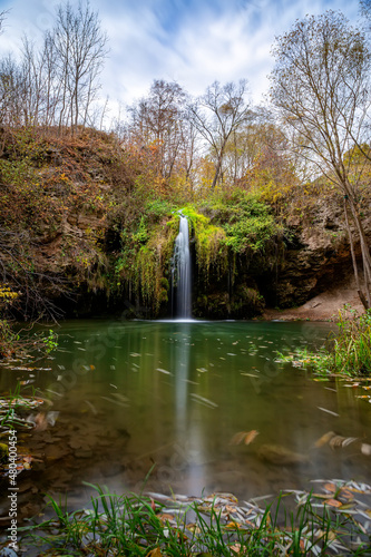 Beautiful waterfall Bourbon with a lagoon in the autumn forest. photo