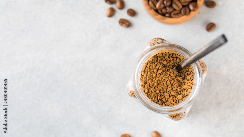 A jar with instant coffee and a spoon inside top view. Copy space. A jar with instant coffee and a spoon inside top view. Copy space.