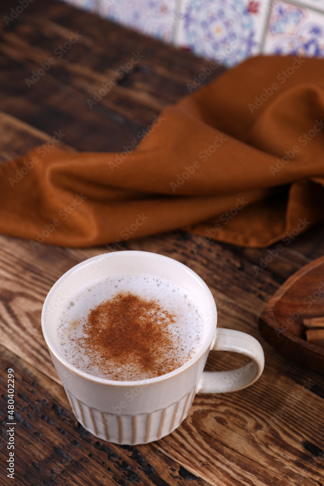Coffee with cinnamon on a wooden table Coffee with cinnamon on a wooden table