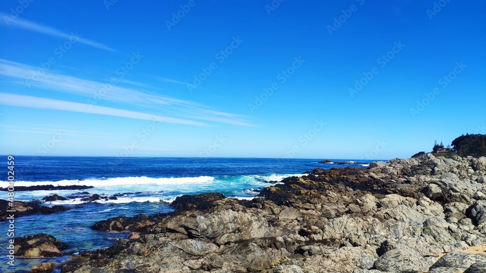 Waves crashing on a rocky beach and blue sky background at Isla Negra, Chile. Waves crashing on a rocky beach and blue sky background at Isla Negra, Chile.