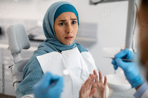Portrait Of Stressed Islamic Lady In Hijab Scared About Dental Treatment