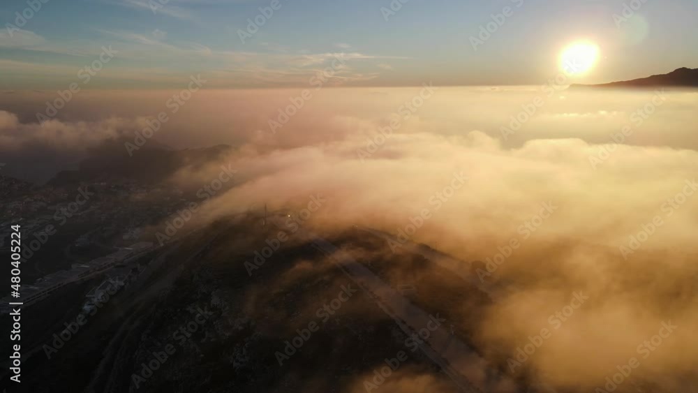 Fooggy sunset in Cumbre del sol. The fog hides the horizon and de coastline. Drone views from Benitachell, Moraira, Calpe and Jávea, in Alicante, Spain Fooggy sunset in Cumbre del sol. The fog hides the horizon and de coastline. Drone views from Benitachell, Moraira, Calpe and Jávea, in Alicante, Spain