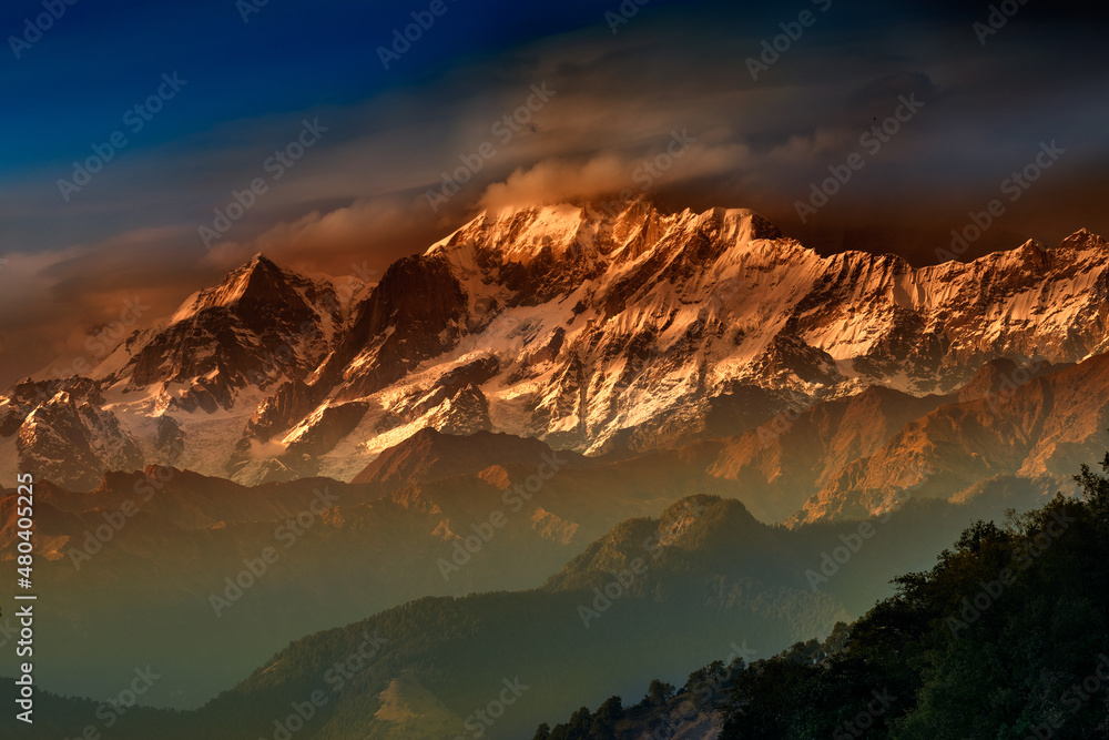 Orange sunset on Chaukhamba , a mountain massif in the Gangotri Group of the Garhwal Himalaya. It lies at the head of the Gangotri Glacier at Uttarakhand, India.