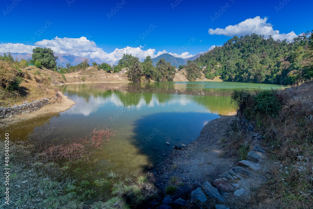 Naklejka premium Deoria Tal , also Devaria or Deoriya is a high altitude lake in Uttarakhand, India. Blue sky with snow-covered mountains, Chaukhamba is one of them, in the background.