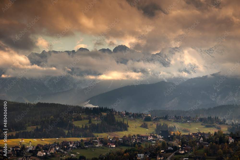 Tatra Mountains seen on a cloudy day. The shining light between the clouds creates an interesting atmosphere in the photo.