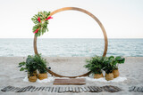 Wedding ceremony Wedding round arch decorated with flowers and vases with greenery Outdoors Sea view background Marriage concept