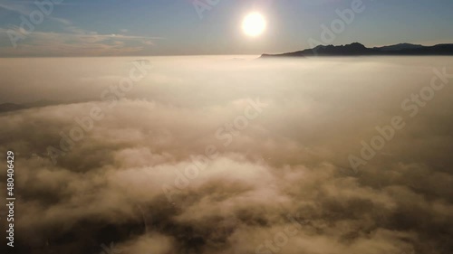 Fooggy sunset in Cumbre del sol. The fog hides the horizon and de coastline. Drone views from Benitachell, Moraira, Calpe and Jávea, in Alicante, Spain photo