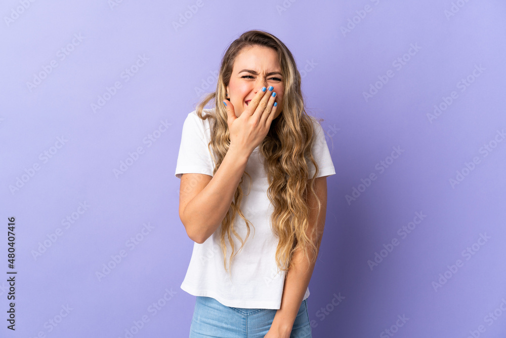 Young Brazilian woman isolated on purple background happy and smiling covering mouth with hand Young Brazilian woman isolated on purple background happy and smiling covering mouth with hand