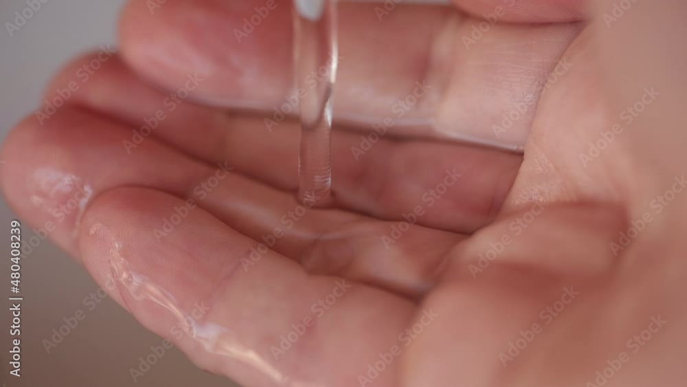 Slow motion: Stream of fresh drinking water pouring into human hands. Slow motion: Stream of fresh drinking water pouring into human hands.