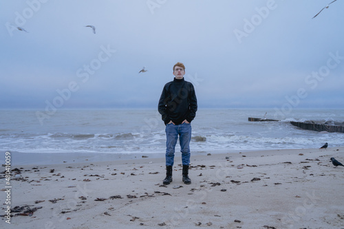 one guy stands in the middle of a stormy sea