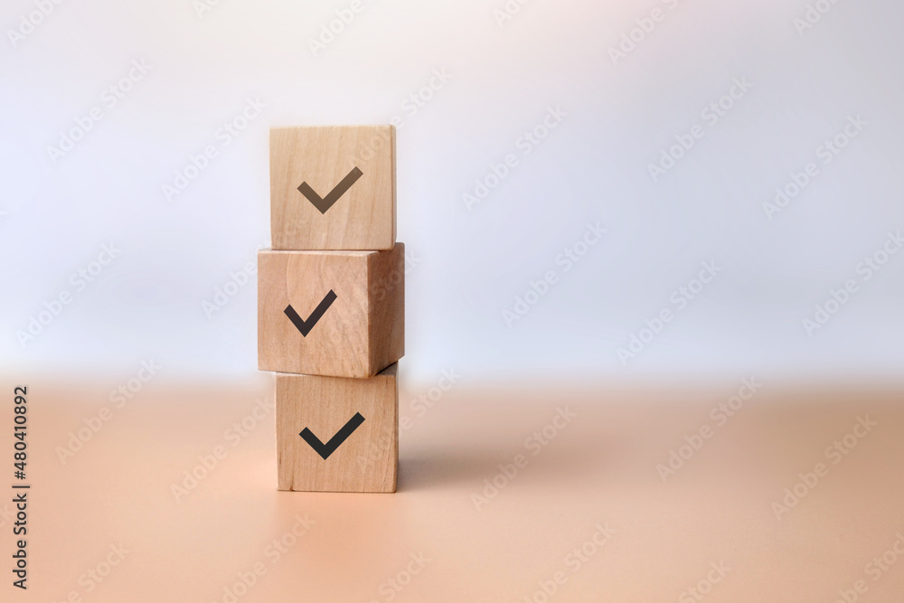 Wooden blocks with drawings of checkmarks. A symbol of consent and correct choice Wooden blocks with drawings of checkmarks. A symbol of consent and correct choice
