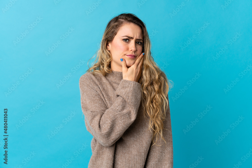 Young Brazilian woman isolated on blue background having doubts Young Brazilian woman isolated on blue background having doubts