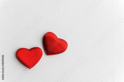 Two red hearts on a white background. Copy space.