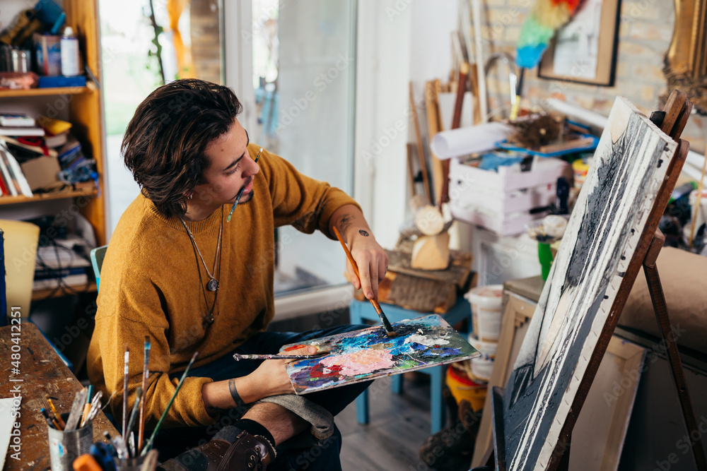 Fototapeta premium man painter working in his atelier