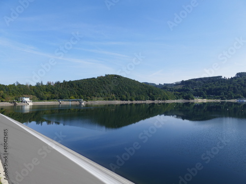 View from the dam of the Biggetalsperre on lake and forests, left the overflow and the winch house, Sauerland, North Rhine-Westphalia, Germany Blick vom Damm der Biggetalsperre auf See und Wälder photo